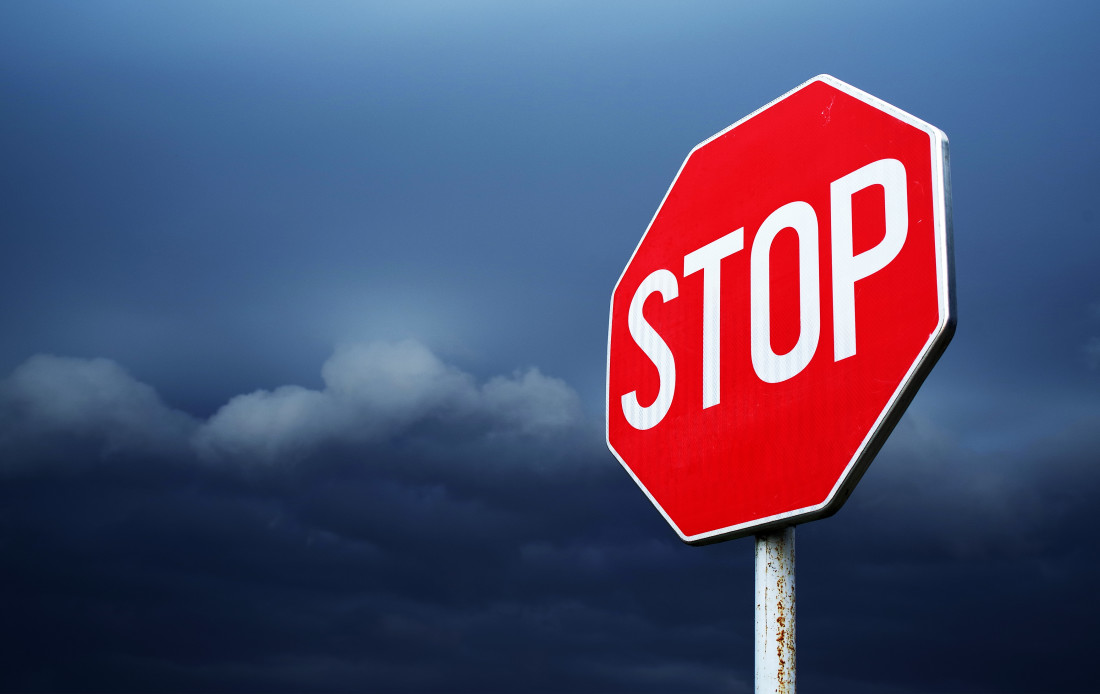 Stop sign on stormy background