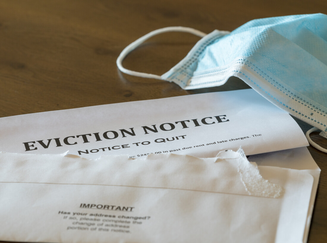 Eviction notice on table next to facemask