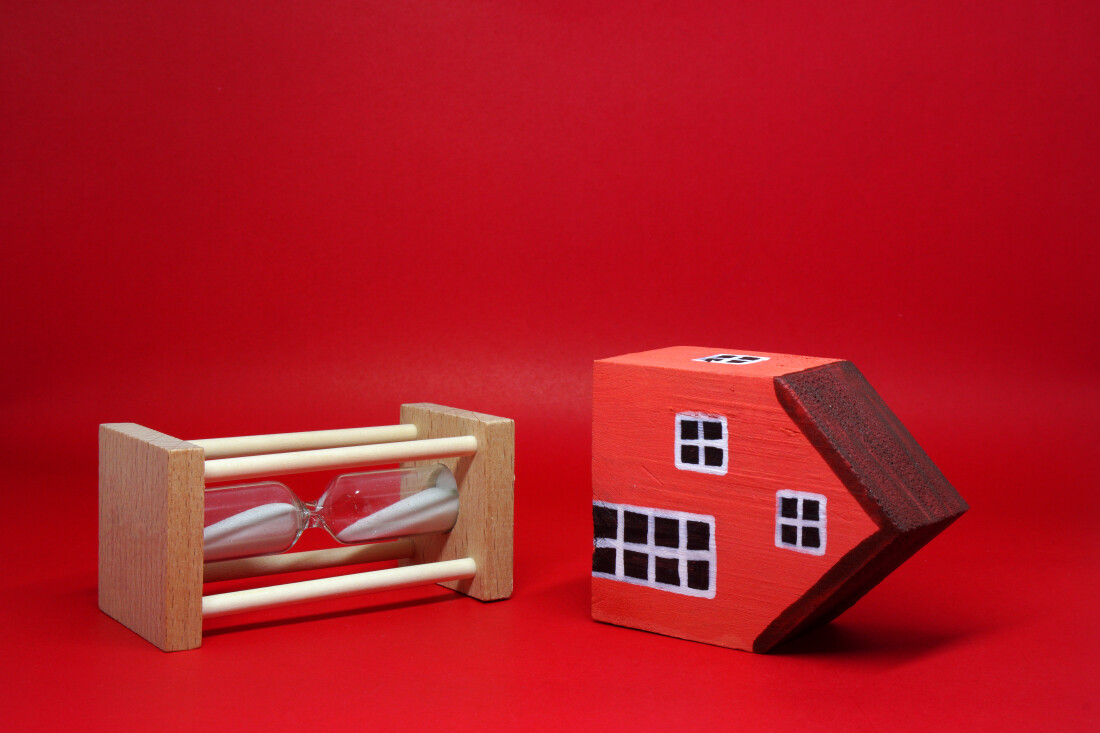 Red House on its side next to sand clock