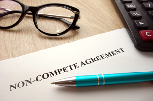 Photo of Non-compete agreement document, glasses, and pens