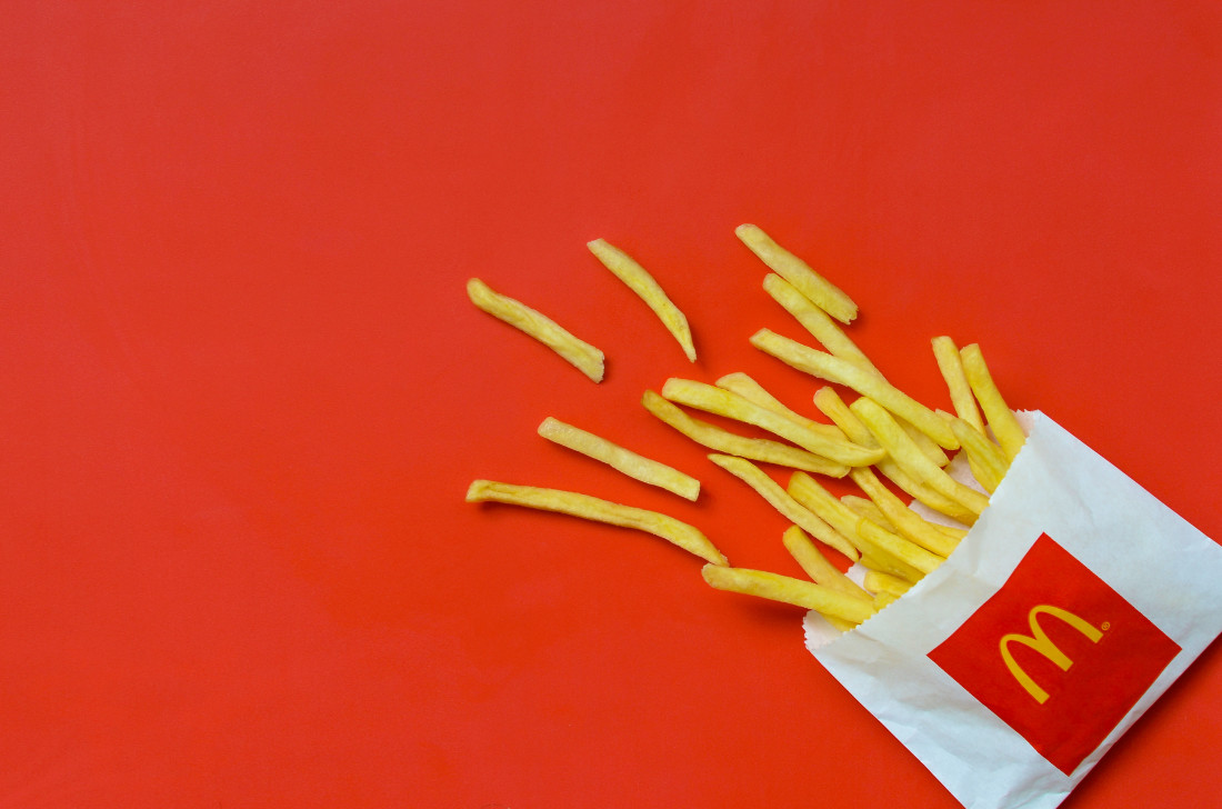 McDonald's french fries in small paperbag on bright red background | Photo by mehaniq41 - stock.adobe.com